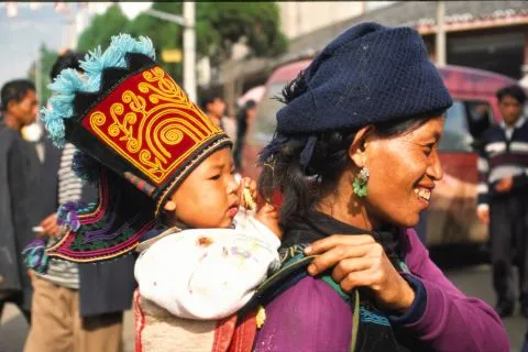Sfeerafbeelding 2730 yi vrouw met een kind op haar rug met de mooiste mao ooit